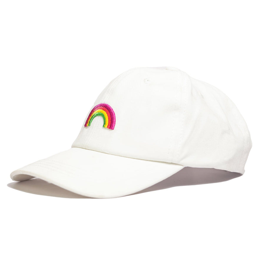 White cotton baseball cap with a three-dimensional rainbow embroidered on the front. The rainbow appears to be raised off the surface of the cap. The cap has an adjustable strap in the back.