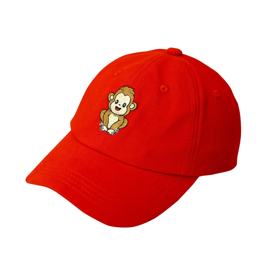 Red cotton baseball cap with a brown monkey embroidered on the front. The cap has an adjustable strap in the back.