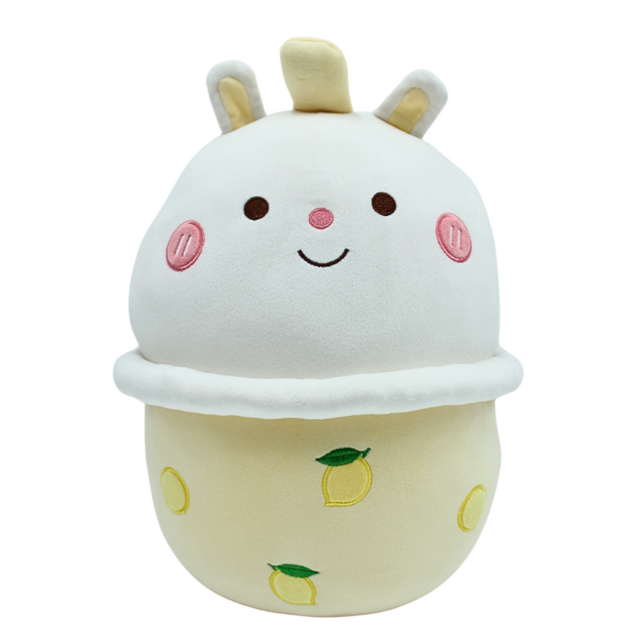 A pink plush toy shaped like a cup of bubble tea with a black straw. The plush toy has a round body with a rounded top, and a smiling face embroidered on the front. - Yellow