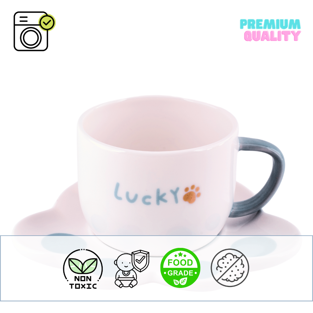 A pastel ceramic mug with a white cat paw shaped saucer beside it. The mug has a smooth finish and appears delicate.
